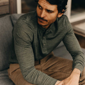 fit model sitting wearing The Merino Henley in Heather Army, Knits by Taylor Stitch