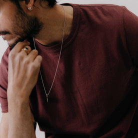 fit model leaning on his hand wearing The Organic Cotton Tee in Dried Cherry, Knits by Taylor Stitch