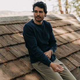 fit model leaning against a roof in The Organic Cotton Waffle Crew in Dark Navy, Knits by Taylor Stitch