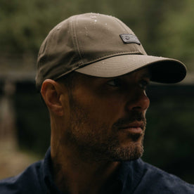 fit model showing off wax finish on The Pathfinder Cap in Fatique Olive Dry Wax, Accessories by Taylor Stitch