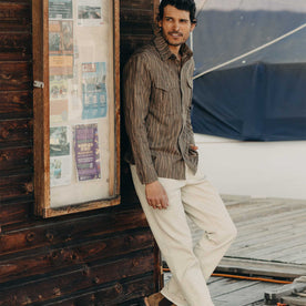 fit model leaning against the wall wearing The Saddler Shirt in Bark Print Broken Twill, Wovens by Taylor Stitch