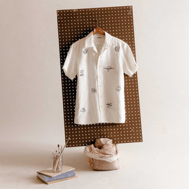 editorial image of The Short Sleeve Davis Shirt in Embroidered Natural hanging, Wovens by Taylor Stitch