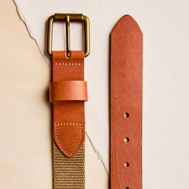 editorial flatlay of the buckle and end The Webbed Belt in Whiskey, Accessories by Taylor Stitch