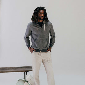 fit model with his hands in his pocket wearing The Apres Zip Hoodie in Graphite French Terry Twill, Knits by Taylor Stitch