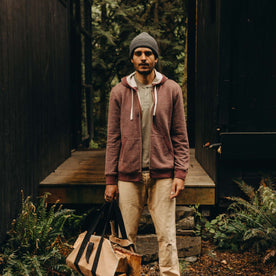 fit model posing in front of a house wearing The Apres Zip Hoodie in Merlot French Terry Twill, Knits by Taylor Stitch