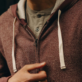 fit model zipping up The Apres Zip Hoodie in Merlot French Terry Twill, Knits by Taylor Stitch