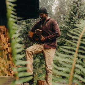 fit model stacking wood wearing The Apres Zip Hoodie in Merlot French Terry Twill, Knits by Taylor Stitch