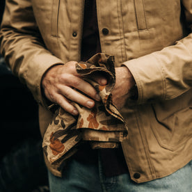 fit model wiping his hands with The Bandana in Arid Camo, Accessories by Taylor Stitch