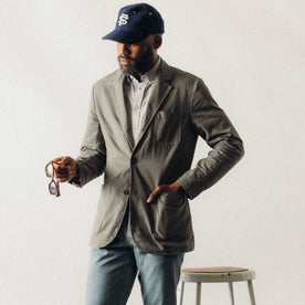 fit model posing in The Foundation Sportcoat in Organic Smoked Olive Twill, Outerwear by Taylor Stitch