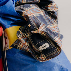 editorial image of The Ledge Shirt in River Plaid on a bag, Wovens by Taylor Stitch