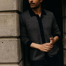 fit model showing off The Nichols Polo in Black Birdseye Merino, Knits by Taylor Stitch