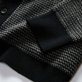 material shot of the sleeves on The Nichols Polo in Black Birdseye Merino, Knits by Taylor Stitch