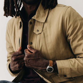 fit model adjusting The Pathfinder Jacket in Khaki Dry Wax, Outerwear by Taylor Stitch