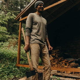 fit model holding an ax wearing The Organic Cotton Henley in Sage, Knits by Taylor Stitch