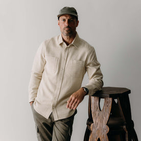 fit model leaning against the wall wearing The Utility Shirt in Natural Sashiko, Wovens by Taylor Stitch