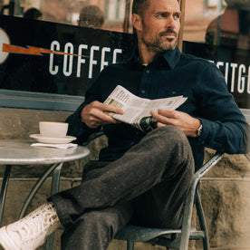 fit model sitting wearing The Utility Shirt in Navy Sashiko, Wovens by Taylor Stitch