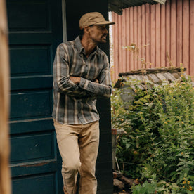 fit model leaning against the wall wearing The Jack in Brushed Heather Grey Plaid, Wovens by Taylor Stitch