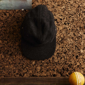 editorial image of The 5-Panel Cap in Heather Coal Wool Blend hanging, Accessories by Taylor Stitch