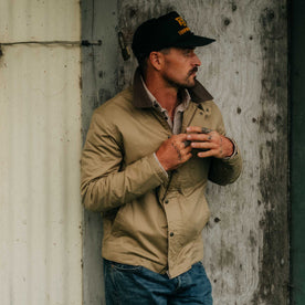 fit model adjusting the zipper on The Deck Jacket in Khaki Dry Wax, Outerwear by Taylor Stitch