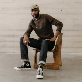 fit model sitting wearing The Eddy Crew in Coffee Herringbone, Knits by Taylor Stitch