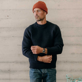 fit model adjusting the cuffs on The Fisherman Sweater in Dark Navy Merino, Knits by Taylor Stitch