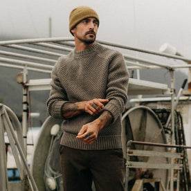 fit model adjusting the cuffs on The Fisherman Sweater in Taupe Merino, Knits by Taylor Stitch