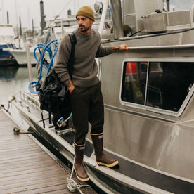 fit model standing on a boat wearing The Fisherman Sweater in Taupe Merino, Knits by Taylor Stitch