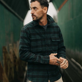 fit model holding his hands wearing The Moto Utility Shirt in Black Pine Plaid, Wovens by Taylor Stitch