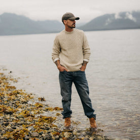 fit model standing in the water wearing The Orr Sweater in Marled Oat Merino, Knits by Taylor Stitch