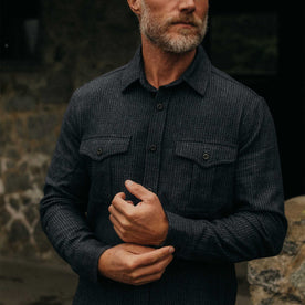 fit model adjusting the cuffs on The Saddler Shirt in Midnight Check Wool, Wovens by Taylor Stitch