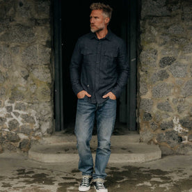 fit model with his hands in his pockets wearing The Saddler Shirt in Midnight Check Wool, Wovens by Taylor Stitch