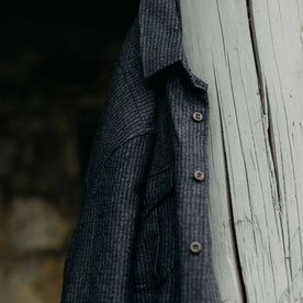 editorial image of The Saddler Shirt in Midnight Check Wool hanging, Wovens by Taylor Stitch