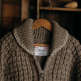 editorial image of The Seawall Hand-Knit Sweater in Heather Sable hanging, Knits by Taylor Stitch