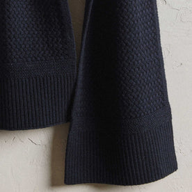 editorial image of the cuffs hanging on The Textured Knit Scarf in Heather Navy Merino, Accessories by Taylor Stitch