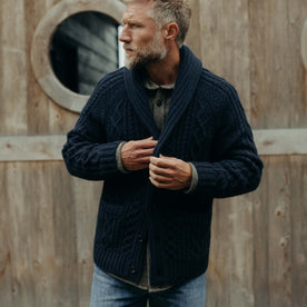 fit model buttoning up The Cascade Shawl Cardigan in Heather Marine, Knits by Taylor Stitch