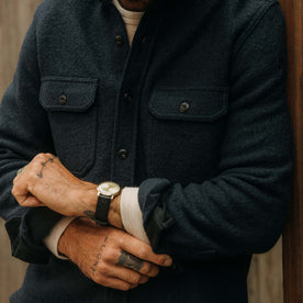 fit model adjusting the cuffs wearing The Connor Overshirt in Dark Navy Boucle, Wovens by Taylor Stitch