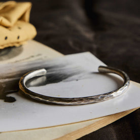 editorial image of The Hammered Cuff in Sterling Silver on a piece of paper, Accessories by Taylor Stitch