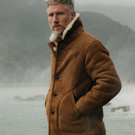 fit model with his hands in his pockets wearing The High Plains Coat in Walnut Shearling, Outerwear by Taylor Stitch