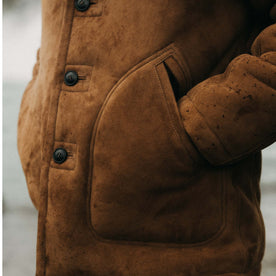 fit model with his hands in the pockets of The High Plains Coat in Walnut Shearling, Outerwear by Taylor Stitch