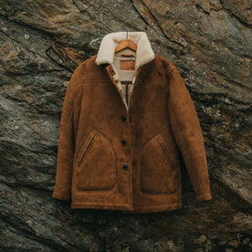 editorial image of The High Plains Coat in Walnut Shearling hanging, Outerwear by Taylor Stitch