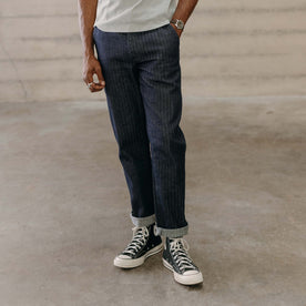 fit model with his hand in the pocket of The Morse Pant in Rinsed Indigo Herringbone, Bottoms by Taylor Stitch