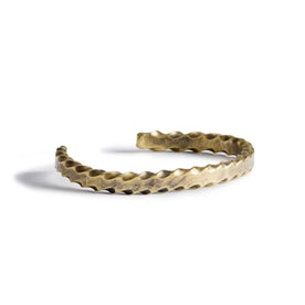 material shot of the side of The Twisted Cuff in Brass, Accessories by Taylor Stitch