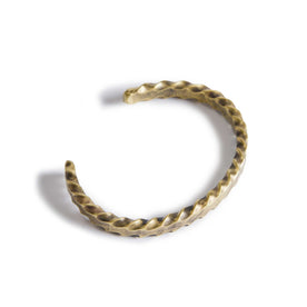 material shot of the top of The Twisted Cuff in Brass, Accessories by Taylor Stitch