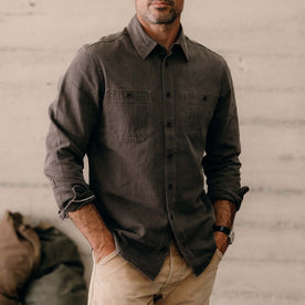 fit model with his hands in his pockets wearing The Utility Shirt in Soil Selvedge Denim, Wovens by Taylor Stitch