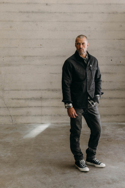 Model wearing The Fender Jacket in Coal Dry Wax with jeans