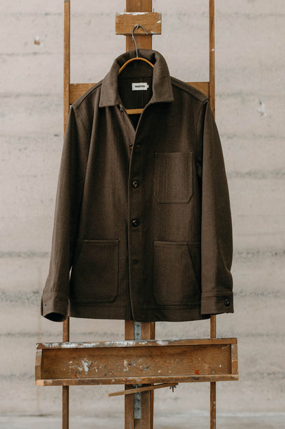 The Ojai Jacket in Army Herringbone Wool hanging on an easel