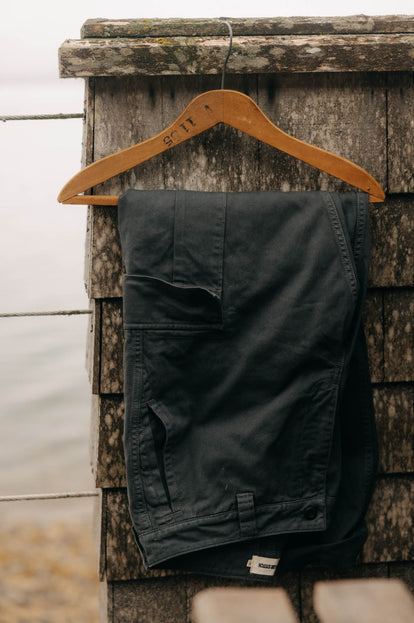 The Tommie Pant in Faded Black on a hanger