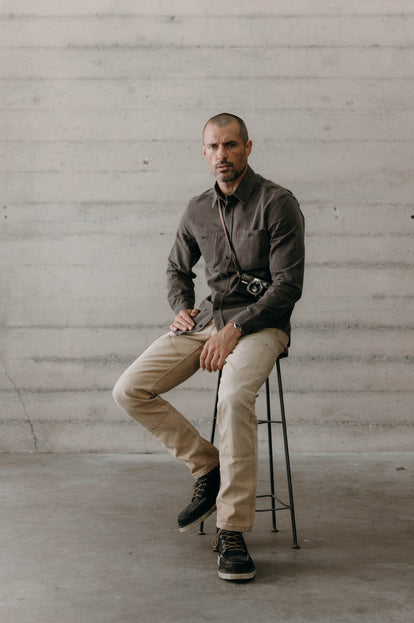 Model sitting on a stool in The Utility Shirt